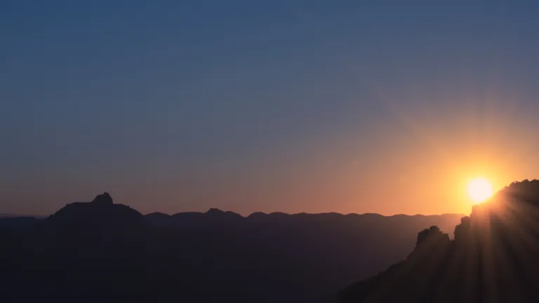 Christ will set up the Kingdom of God following His return to the earth. Sunset over mountains.
