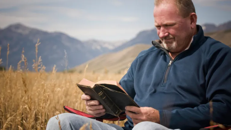 A man reading a Bible.