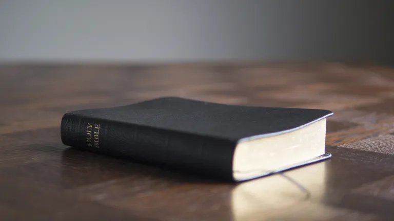 Only by having constant access to a living, permanent High Priest is it possible for us to obey God in a manner that pleases Him. Bible laying on top of a table