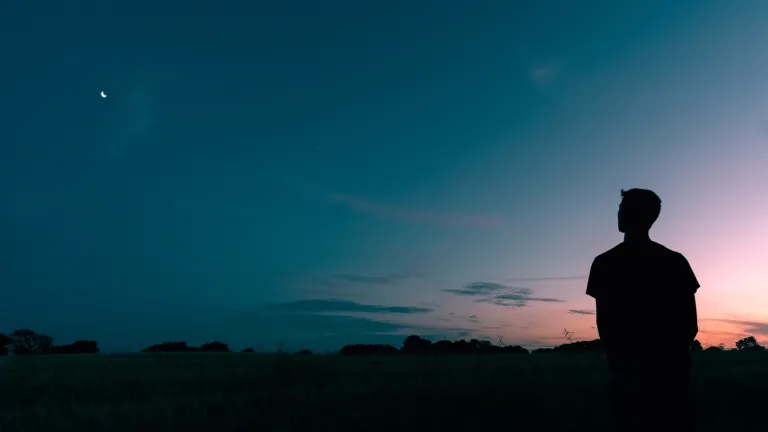 The Ten Commandments expand those principles of love. God desires to write the fullness of these principles in our hearts. A person looking at a sunset.