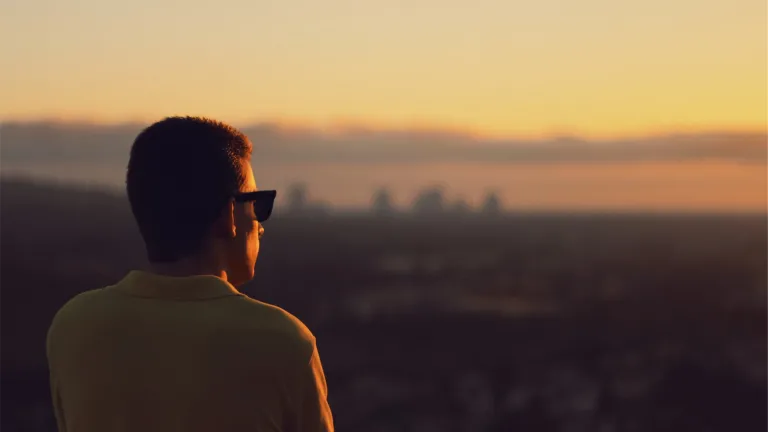Without the positive influence of God's Spirit, we are simply not inclined to live according to God's instructions. A man looking at a sunrise.