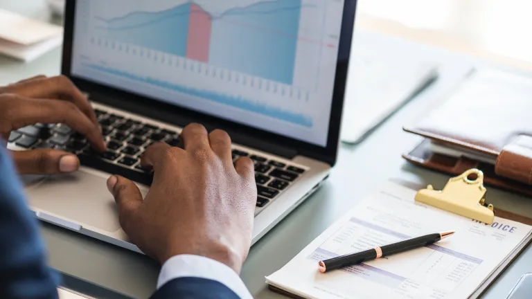 Credit counselors are not a quick fix. You will still need to have the vision to stick with a budget and work hard to find your way out of financial trouble. A person working on a laptop with financial charts.