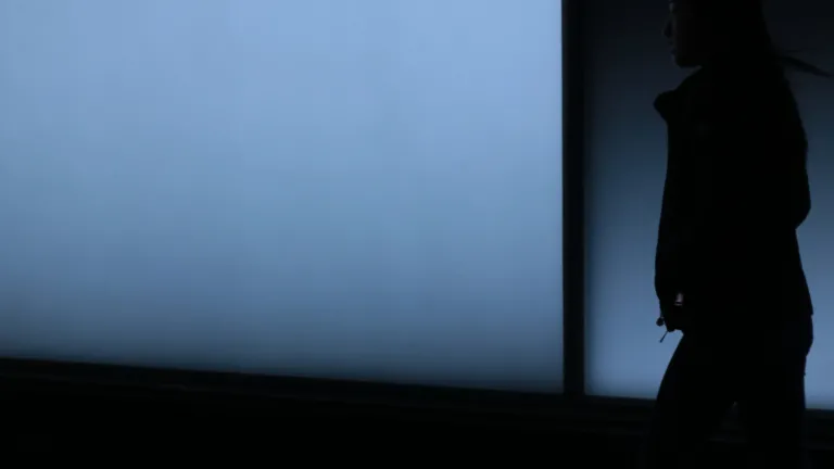 A silhouette of a person walking.