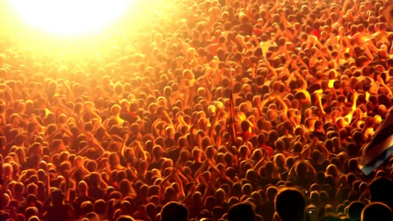 Crowd of people in bright light.