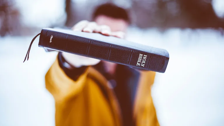Jesus Christ and the remainder of the Bible make one thing perfectly clear: Proper obedience to the law of God is not legalism. A man holding a Bible.