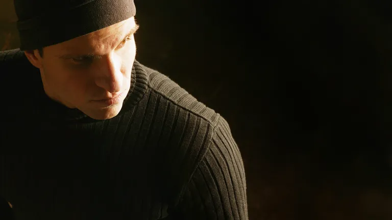 A man ready to break into a house and steal.