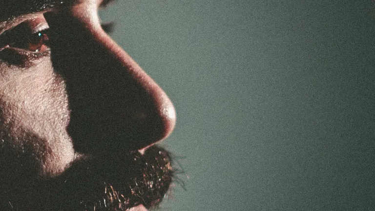 A up close photo of a man's face and beard.