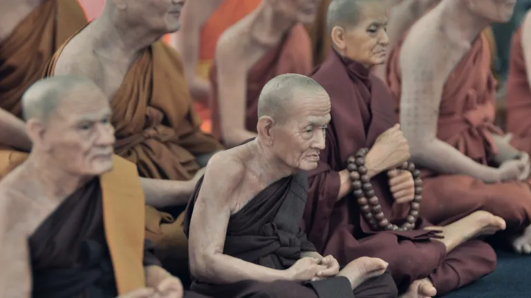 Buddhist monks sitting on the floor.