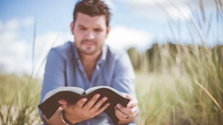 A man reading a Bible.