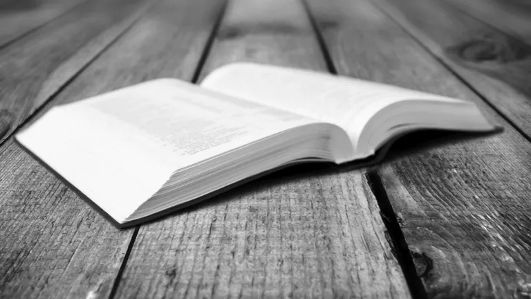 A open Bible laying on a table.