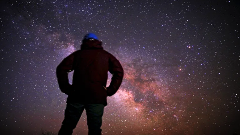 Despite this vast, incredible creation that God has wrought—with all of those planets, stars, solar systems and galaxies spinning in predictable motion, He also created mankind. A person staring at the night sky filled with stars.