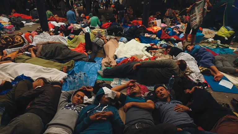 Syrian refugees sleep on the floor of a railway station in Hungary.