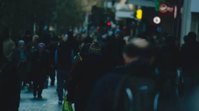 People walking on a crowded city street.