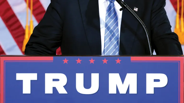 Interesting times are ahead as America struggles for its identity and future in a population divided between fiercely opposite and contradictory visions. Will the new president follow through on his promises? A lectern with a Trump poster on the front.