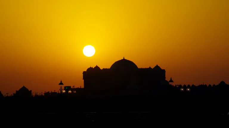 A sunset over a Muslim mosque.