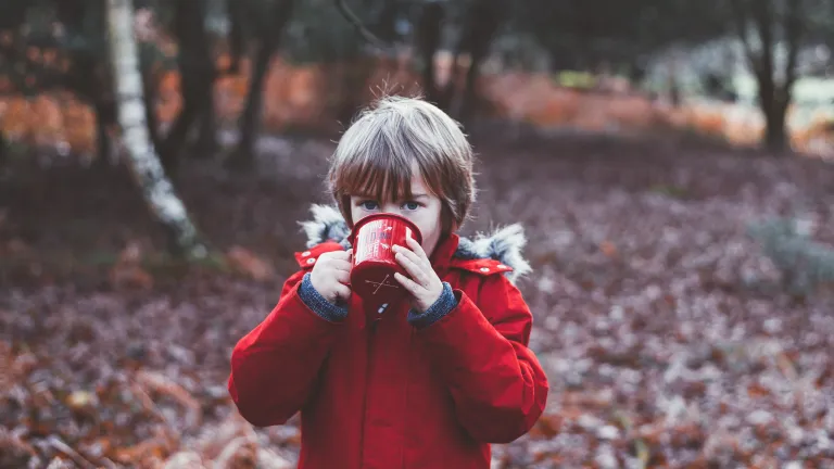 A little boy from a camp mug.