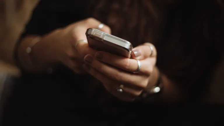 Are you seeking relief in the distractions always readily available on your smartphone? A woman using a smartphone.