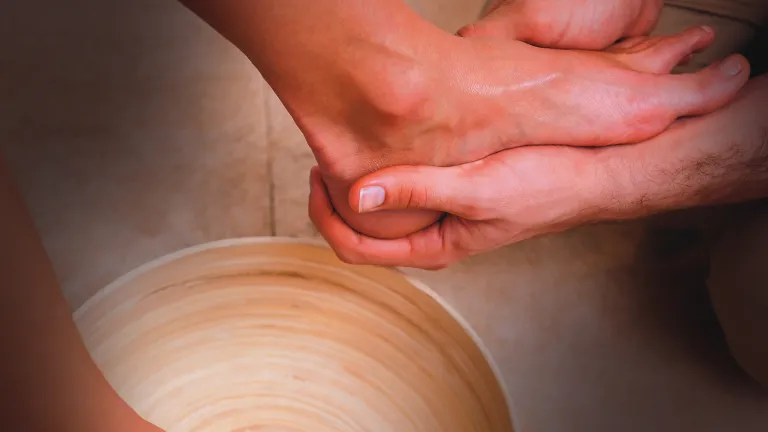 A person washing another person's foot.