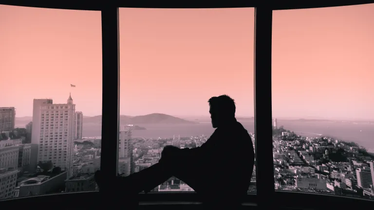 The truth is that all who have not heard or understood the gospel will have a chance to believe it. God will resurrect them to physical life and give them the opportunity to believe and inherit eternal life! A man sitting in a window sill looking out over a city skape.