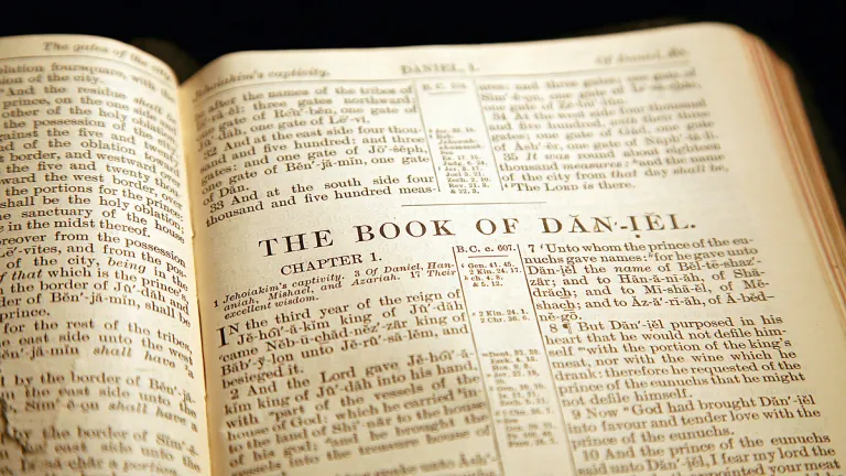 In the book of Daniel, we are introduced to certain angels mentioned by name. A Bible opened to the book of Daniel.