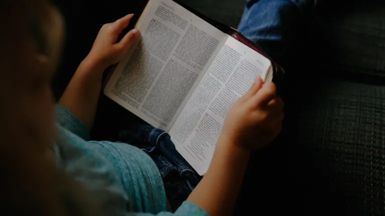 Fasting is for one's spiritual health, which involves abstaining from food and drink while spending a lot of extra time in prayer and Bible study. A person reading a Bible.