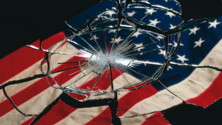 Bible prophecy explains why our world is dangerous. It also provides hope, which removes fear. Let’s look at what’s happening, and let’s understand why. A shattered American flag in glass.