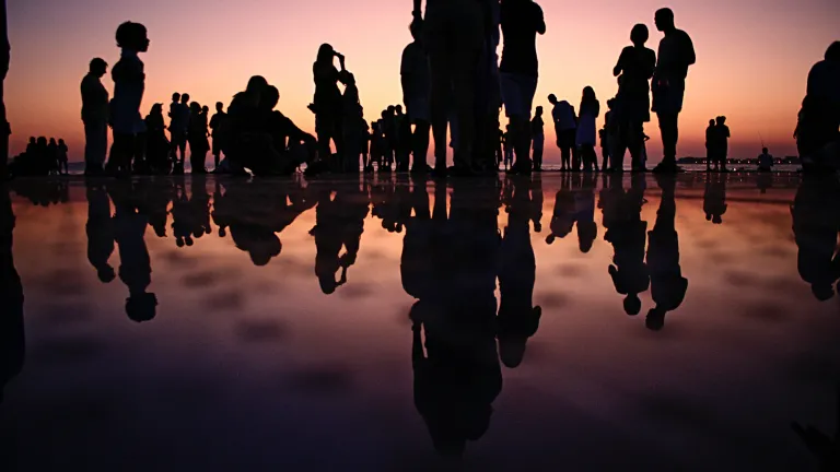 A group of people at sunset.