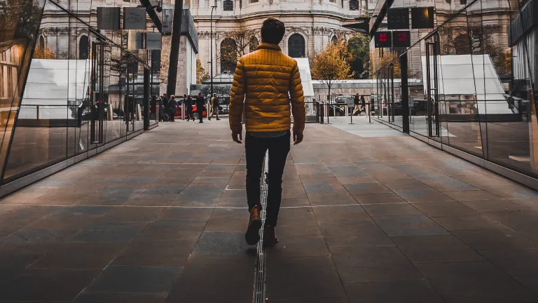 God is grieved when He sees any of His beautiful children heading down a path that leads away from eternal life and away from the everlasting joy He wants to share with them. A man walking down a road in between to buildings.