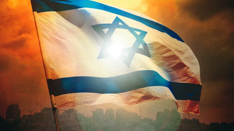 The state of Israel’s formation and continued existence have been according to God’s plan. Israeli flag with Jerusalem in the background.