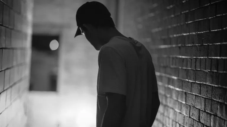A man in a dark hallway.