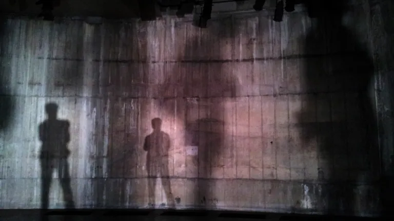Two mysterious figures the Bible calls “the Beast” and “the False Prophet” will play prominent roles in prophesied end-time events. Silhouettes of two people on a grungy wall.
