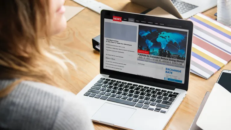 God is fully aware of the atrocities that happen in our world and will intervene when the time is right for mankind to have a receptive heart to His judgment and teaching. A woman looking at news items on a laptop.