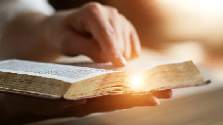 Knowing God, knowing His truth and living by His Word brings wonderful assurance, comfort and real peace. An open Bible with someone's hand pointing to a scripture.