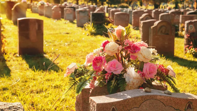 Headstones and flowers at a cemetery.
