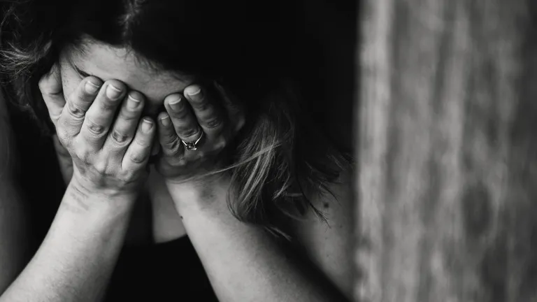 Grief can be a healing force—but it needs to be allowed to pass before it becomes a time when we are only feeling sorry for ourselves. A woman holding her head in her hands grieving.