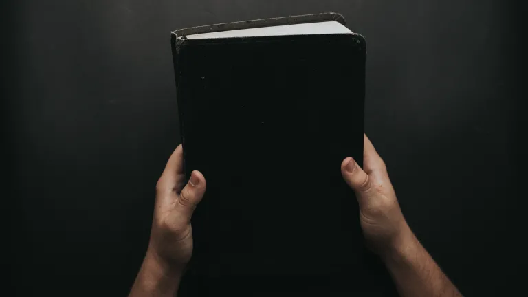 God’s clear warnings against idolatry are found in numerous biblical passages. A person holding a Bible.