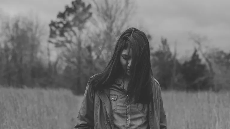 A woman walking in a field.