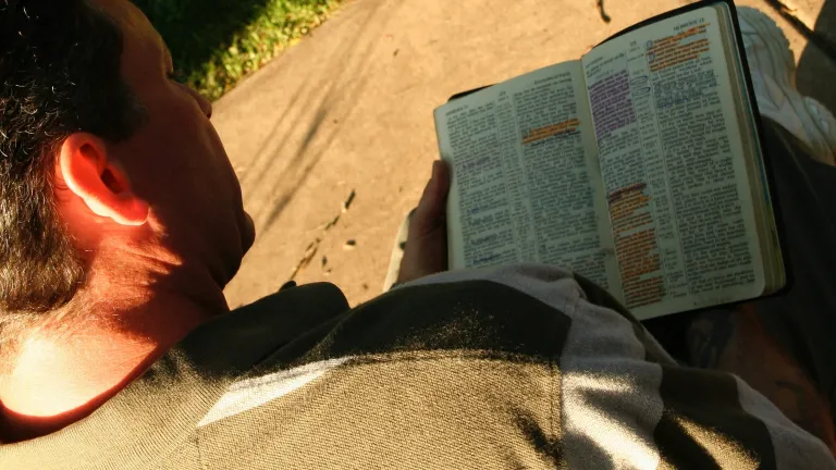 The New Testament is filled with instruction to keep the Ten Commandments. A man reading a Bible.