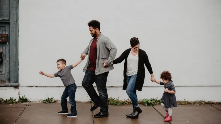 A family walking down a sidewalk.