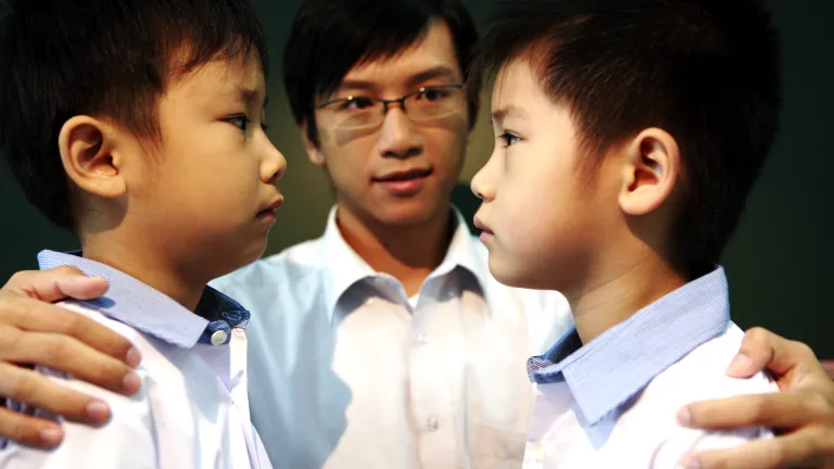Two boys angrily looking at each other.