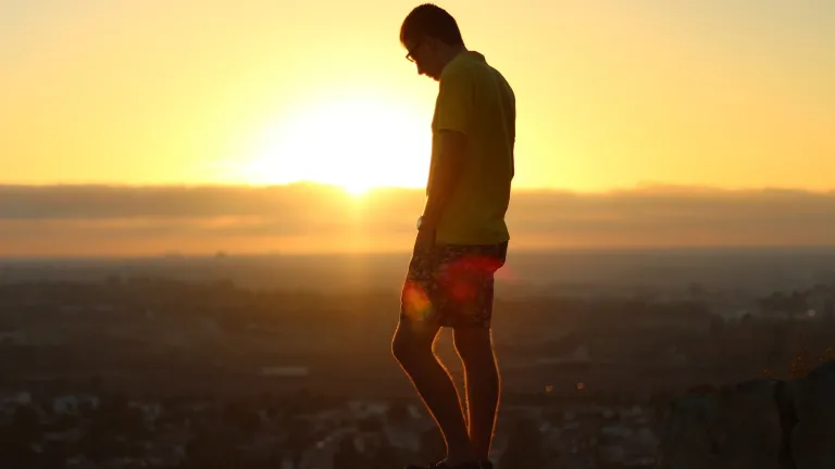Being a friend of God, being in the good graces of God, opens the door for God to shower us with grace, with forgiveness, with restoration, with redemption, with reconciliation. A young man standing on a hill overlooking a village.
