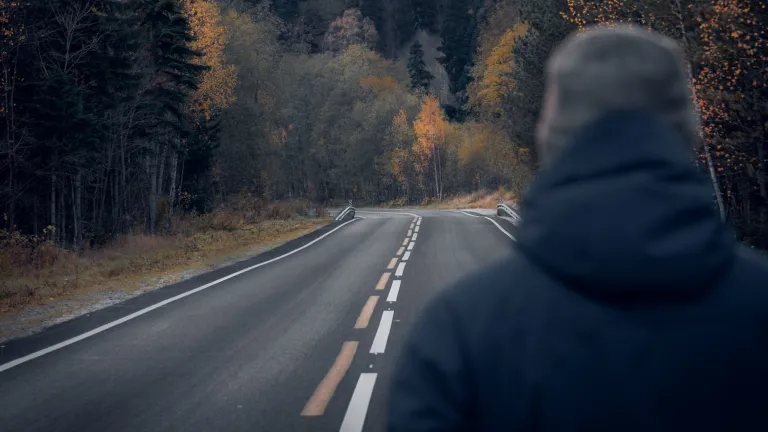 A man looking at a road.