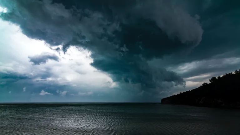 Photo of storm clouds over the ocean.