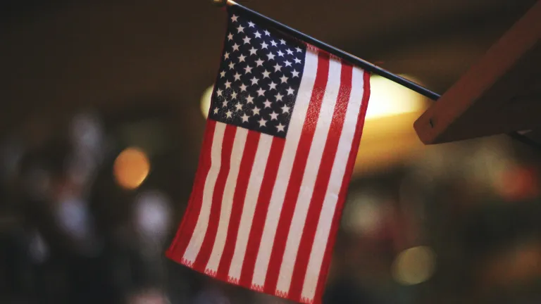 Despite the wrongs they have done, the American and British people have used their great blessings to help bless the rest of the world in many ways. An American flag.