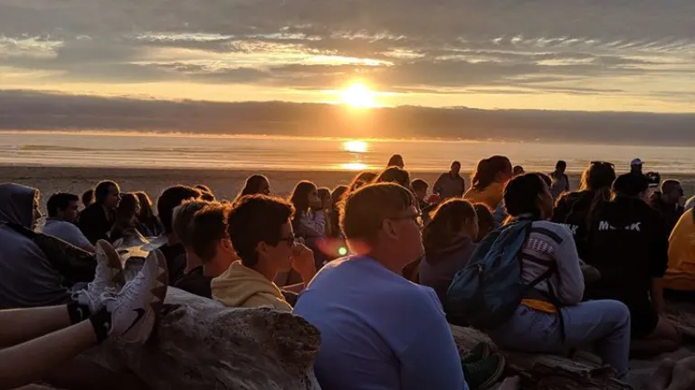 Sunset over a group of campers on the coast