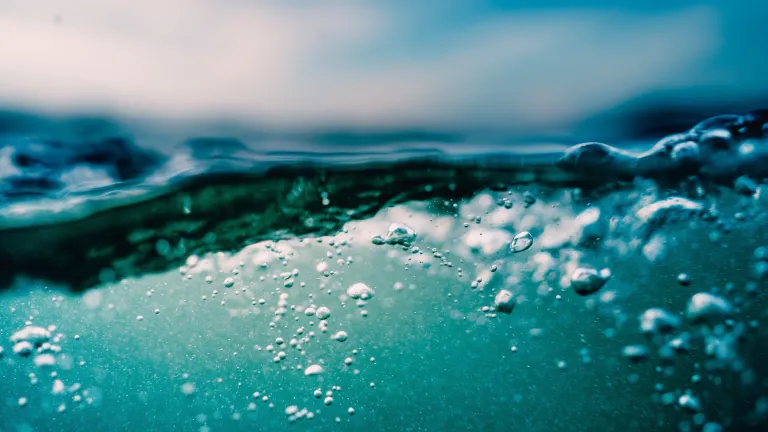 Being put into and under water pictures a burial, and rising from the water pictures a resurrection. Water bubbles.