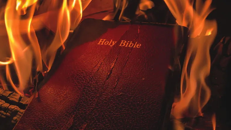 When people ”cancel God” by forsaking Him, they cut themselves off from the only source of true values and are left flailing in blind ignorance and suffering. A burning Bible.