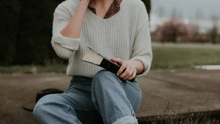 Cancel culture’s war on biblical morality has done much to turn nations toward that darker path. Your Bible indicates this situation will only get worse. A woman sitting on the ground holding a Bible.