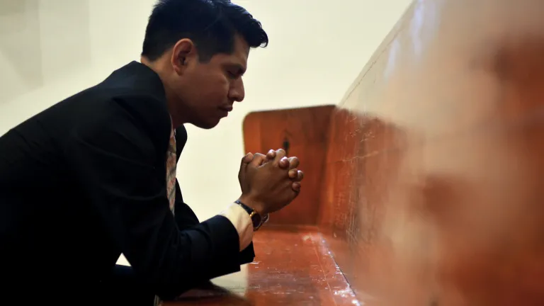 Reconciliation requires repentance, an admission of wrongdoing and a concerted effort to change sinful behavior into righteousness. a man with hands folded in prayer