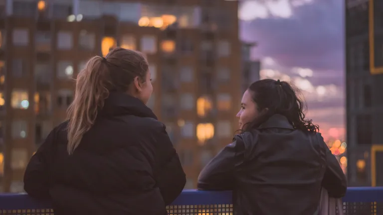 We need to bear with one another, so we’ll be in the position to show support and concern. Two young women talking to each other.